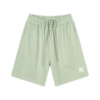 Short en coton vert clair avec taille élastique, longs cordons et poches latérales